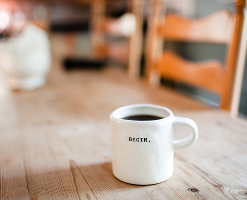 Photo of a mug with the word Begin printed on it.